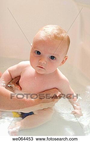8 week old baby inthe bath looking into camera with a very serious expression View Large Photo Image Stock Image - 8 week old baby inthe bath looking into camera with a very serious expression. Fotosearch