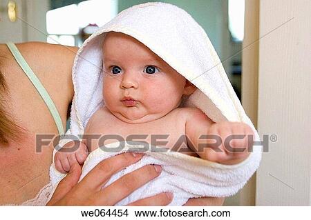 8 week old baby wrapped up in a fluffy towel looking off camera View Large Photo Image Picture - 8 week old baby wrapped up in a fluffy towel looking off camera. Fotosearch