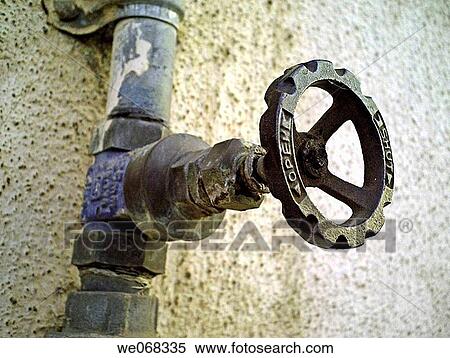 Stock Photography - A revolving cock, tap of a water pipeline going to an overhead water storage on a building teracce. Pune, Maharashtra, India.. Fotosearch