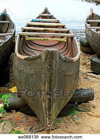 A small fishing boat on a beach at Beypore. Calicut, Kerala, India. View Large Photo Image Stock Photo - A small fishing boat on a beach at Beypore. Calicut, Kerala, India.. Fotosearch
