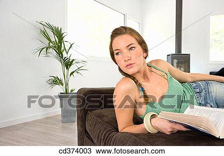 Stock Image - absent-mindedness, brunette, book, at-home, Absent-minded. Fotosearch
