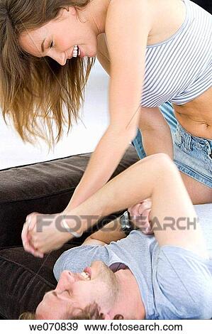 Stock Photo - activity, at-home, amusement, affection, 20's. Fotosearch