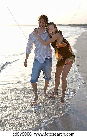 affection, beach, barefoot, amusement, 20's View Large Photo Image Stock Photograph - affection, beach, barefoot, amusement, 20's. Fotosearch