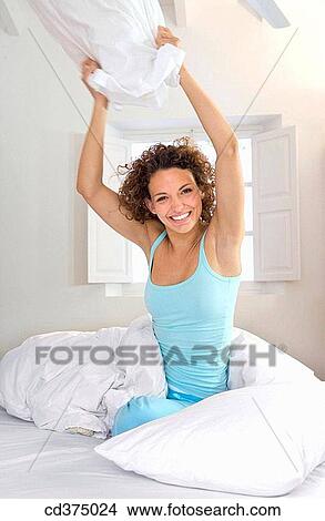 Picture - amusement, bed, at-home, Arms raised, activity. Fotosearch