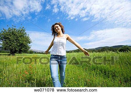 Stock Photo - amusement, brunette, Arms open, 20's. Fotosearch