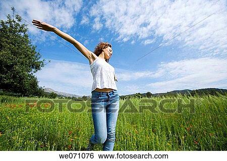 Stock Photograph - amusement, brunette, Arms open, 20's. Fotosearch