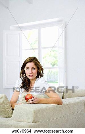 apple, brunette, at-home, 20's View Large Photo Image Picture - apple, brunette, at-home, 20's. Fotosearch