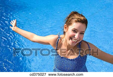 Arms open, brunette, blue, amusement View Large Photo Image Stock Photo - Arms open, brunette, blue, amusement. Fotosearch