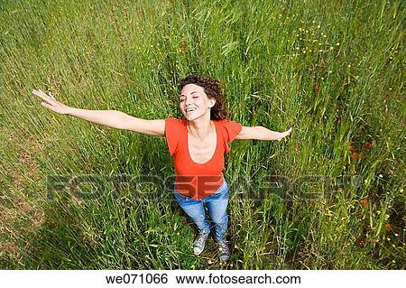 Arms open, carefree, brunette, 20's View Large Photo Image Stock Photograph - Arms open, carefree, brunette, 20's. Fotosearch