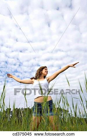 Arms open, carefree, brunette, 20's View Large Photo Image Stock Photography - Arms open, carefree, brunette, 20's. Fotosearch