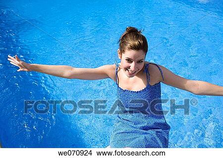 Arms open, carefree, brunette, blue, amusement View Large Photo Image Picture - Arms open, carefree, brunette, blue, amusement. Fotosearch