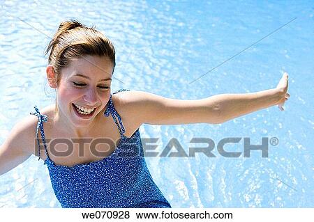 Arms open, carefree, brunette, blue, amusement View Large Photo Image Stock Photo - Arms open, carefree, brunette, blue, amusement. Fotosearch