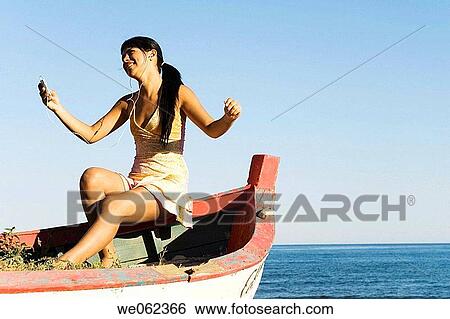 Arms open, carefree, brunette, boat, amusement View Large Photo Image Stock Photograph - Arms open, carefree, brunette, boat, amusement. Fotosearch