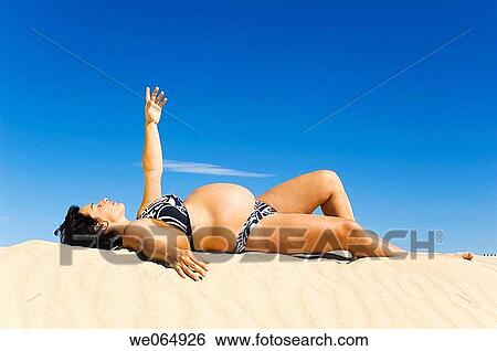 Arms raised, beach, 30's View Large Photo Image Stock Photograph - Arms raised, beach, 30's. Fotosearch