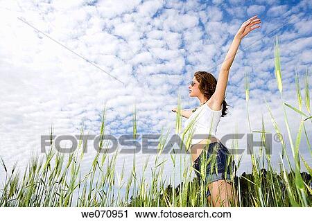 Arms raised, carefree, brunette, 20's View Large Photo Image Stock Image - Arms raised, carefree, brunette, 20's. Fotosearch