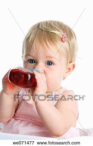 Stock Photo - baby, Baby bottle, blond, blue eyes, child. Fotosearch