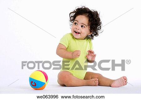 Stock Photograph - baby, ball, barefoot, Brown eye, brunette, child. Fotosearch