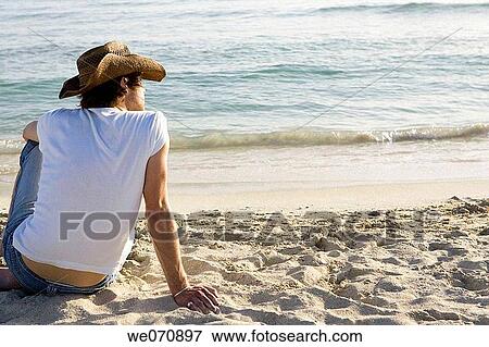 Stock Photo - back view, beach, calm. Fotosearch