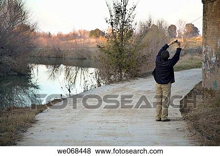 Stock Photo - back view, camera, calm, Arms raised. Fotosearch