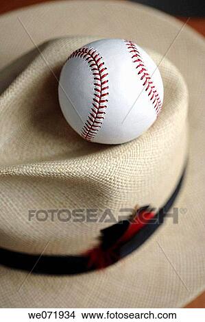 Baseball sitting on top of mens straw hat View Large Photo Image Picture - Baseball sitting on top of mens straw hat. Fotosearch
