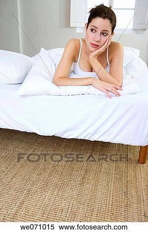 Stock Photography - bed, calm, brunette, bedroom, absorbed. Fotosearch