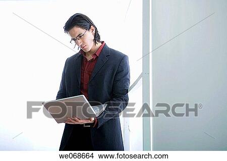 Picture - black hair, businesspeople, businessman, 20's. Fotosearch
