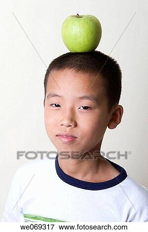 boy, aiming, balance, Asian, apple, aim View Large Photo Image Stock Photo - boy, aiming, balance, Asian, apple, aim. Fotosearch