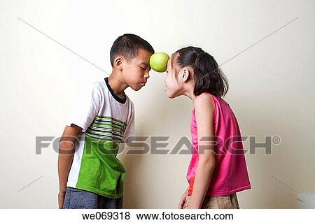 brother, apple, boy, balance, Asian, amusement View Large Photo Image Stock Photo - brother, apple, boy, balance, Asian, amusement. Fotosearch