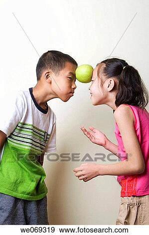brother, apple, boy, balance, Asian, amusement View Large Photo Image Stock Photo - brother, apple, boy, balance, Asian, amusement. Fotosearch