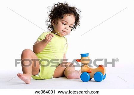 brunette, baby, biting, bite, barefoot, amusement View Large Photo Image Stock Image - brunette, baby, biting, bite, barefoot, amusement. Fotosearch