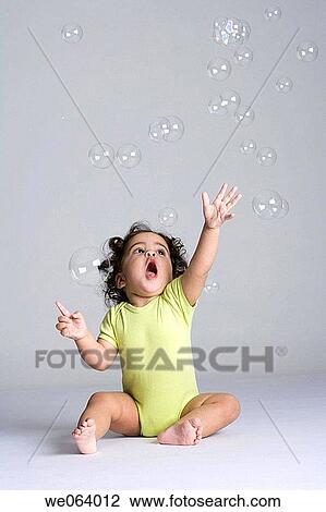 bubble, Arms raised, brunette, barefoot, baby, amusement View Large Photo Image Stock Image - bubble, Arms raised, brunette, barefoot, baby, amusement. Fotosearch