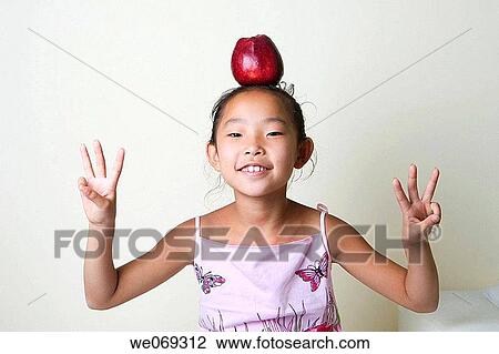 child, aiming, balance, Asian, apple, aim View Large Photo Image Stock Image - child, aiming, balance, Asian, apple, aim. Fotosearch