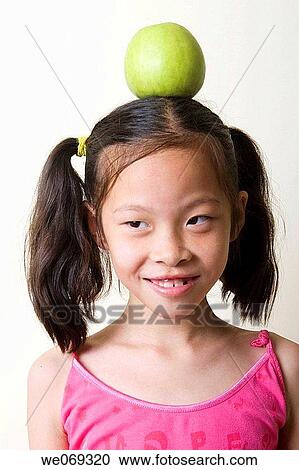 child, aiming, balance, Asian, apple, aim View Large Photo Image Stock Image - child, aiming, balance, Asian, apple, aim. Fotosearch