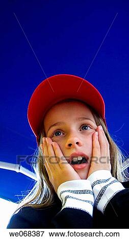 Child alarmed with red cap and blue sky View Large Photo Image Stock Photo - Child alarmed with red cap and blue sky. Fotosearch
