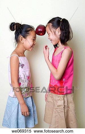 childhood, apple, child, balance, Asian, amusement View Large Photo Image Stock Photography - childhood, apple, child, balance, Asian, amusement. Fotosearch