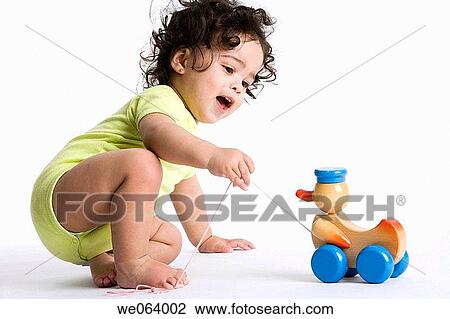 Stock Image - childhood, baby, child, brunette, barefoot, amusement. Fotosearch