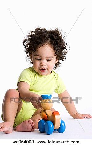 childhood, baby, child, brunette, barefoot, amusement View Large Photo Image Stock Image - childhood, baby, child, brunette, barefoot, amusement. Fotosearch