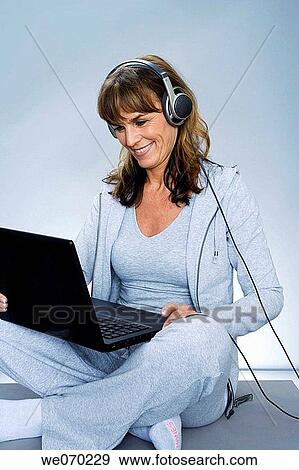 Stock Photo - computer, contemporary, cross-legged. Fotosearch