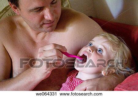 father brushing his daughters teeth for bed View Large Photo Image Stock Image - father brushing his daughters teeth for bed. Fotosearch