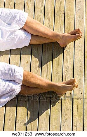 Four legs and feet with white bathrobes on wooden boardwalk. View Large Photo Image Stock Image - Four legs and feet with white bathrobes on wooden boardwalk.. Fotosearch