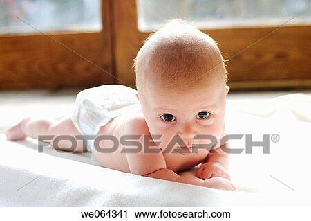four week old baby lying on his tummy looking into camera View Large Photo Image Stock Image - four week old baby lying on his tummy looking into camera. Fotosearch