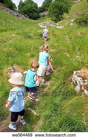 group of children on a walk in he counryside all following each other in a line View Large Photo Image Stock Photo - group of children on a walk in he counryside all following each other in a line. Fotosearch