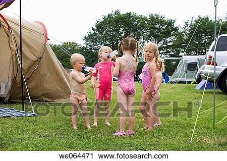 group of five children standing in a group in their swimwear, on a camping trip View Large Photo Image Stock Image - group of five children standing in a group in their swimwear, on a camping trip. Fotosearch