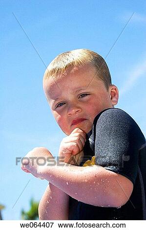 headshot of a 5 year old boy looking into camera holding his arms up in defence View Large Photo Image Stock Photo - headshot of a 5 year old boy looking into camera holding his arms up in defence. Fotosearch