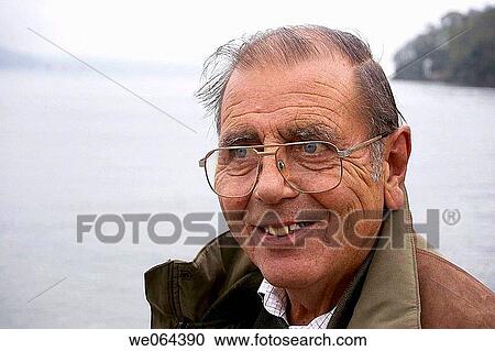 headshot of a 75 year old man, smiling off camera, with the sea behind him View Large Photo Image Stock Image - headshot of a 75 year old man, smiling off camera, with the sea behind him. Fotosearch