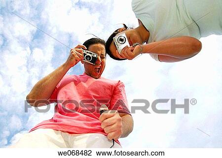 Man and woman holding cameras. View Large Photo Image Stock Image - Man and woman holding cameras.. Fotosearch