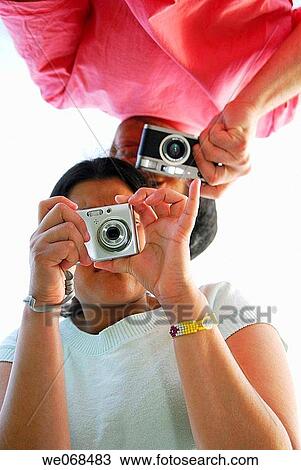 Man and woman holding cameras. View Large Photo Image Stock Image - Man and woman holding cameras.. Fotosearch