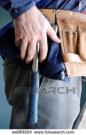 Man gripping his hammer. Craftsman, workman, renovation. Sweden, Scandinavia, Europe View Large Photo Image Picture - Man gripping his hammer. Craftsman, workman, renovation. Sweden, Scandinavia, Europe. Fotosearch