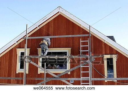 Man painting a house. Craftsman, workman, renovation. Sweden, Scandinavia, Europe View Large Photo Image Stock Photography - Man painting a house. Craftsman, workman, renovation. Sweden, Scandinavia, Europe. Fotosearch