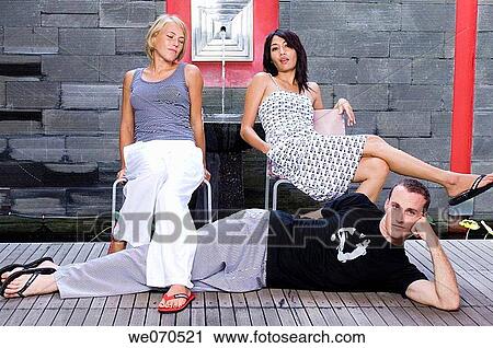 Man posing with two women View Large Photo Image Stock Image - Man posing with two women. Fotosearch